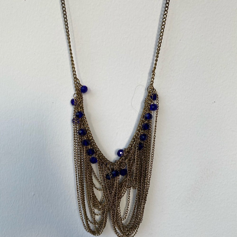 Gold chain necklace with blue bead detail